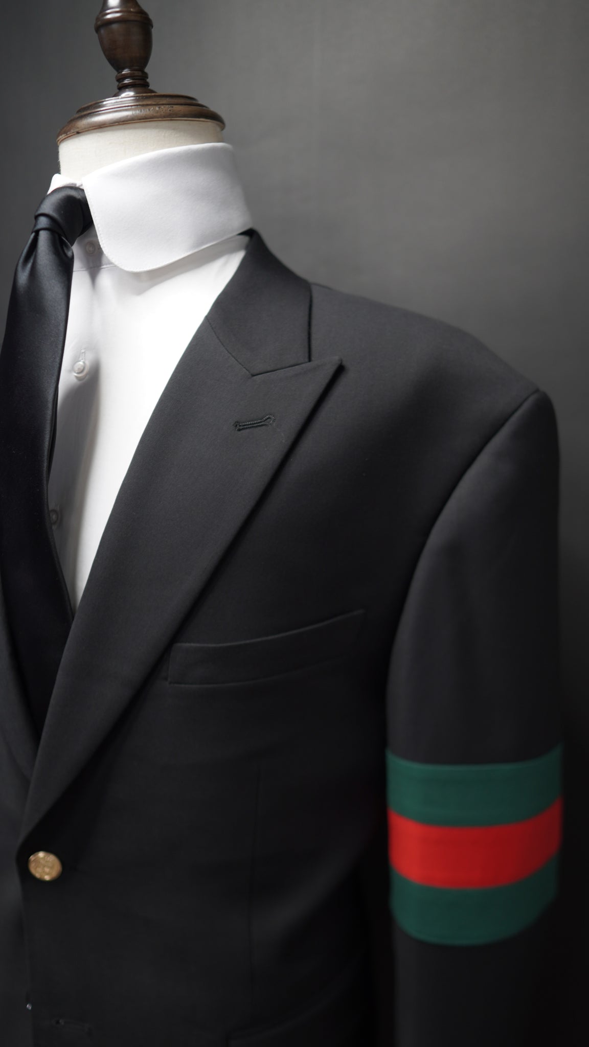 Black Peak lapel suit with Green & Red Armband